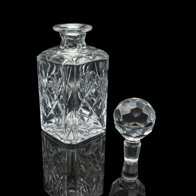 This is a vintage executive whiskey decanter. An English, cut crystal glass spirit vessel, dating to the late 20th...
