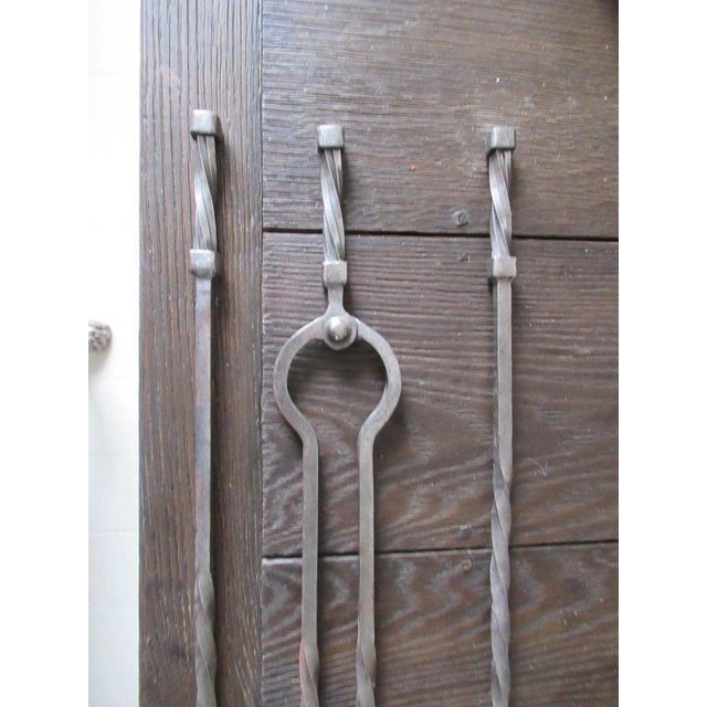 Late 18th century. A set of three early Gothic twisted steel fire irons of large size. H 33.5 in. x Dm .7 in. H 85.09 cm x...
