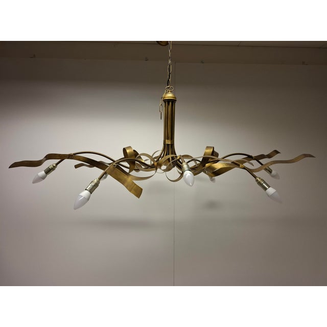 This - probably French - chandelier is very similar to the Ruban Plié by Jacco Maris,it is a charming, contemporary...