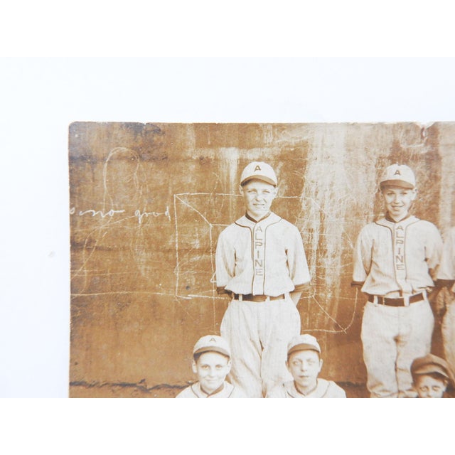Early 20th century snapshot real photo post card RPPC photograph of an Alpine school baseball team in front of a graffiti...