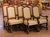This elegant suite of ten Louis XIII style dining chairs, crafted circa 1980, includes eight side chairs and two...