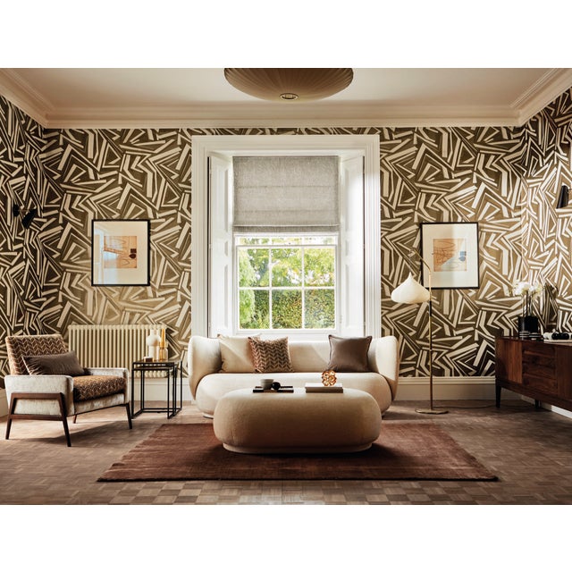 Inky brush mark detail casts subtle shapes and shadows across the ground of this showstopping wide-width wallpaper...