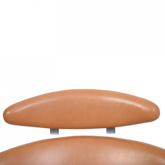 Erik Jørgensen Corona chair upholstered with original Walnut Elegance leather, and with a frame of brushed steel. The...