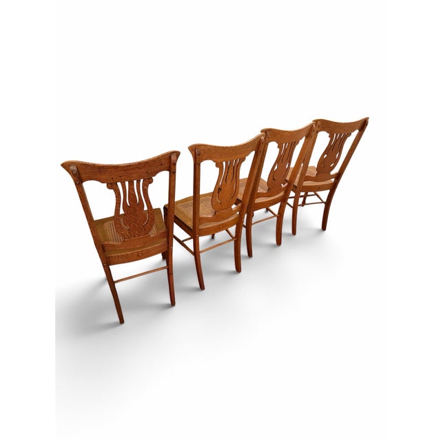 Set of four gorgeous antique Quarter-Sawn Art Nouveau Tiger Oak dining chairs dating to approximately 1900–1910....