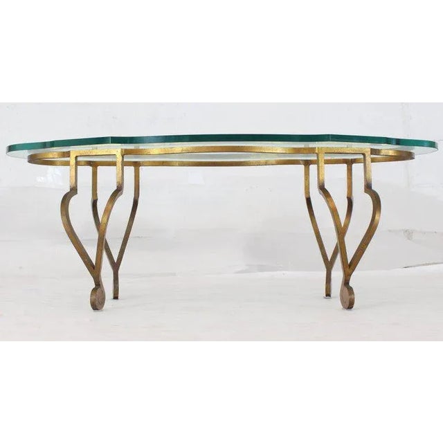 Decorative figural oval wrought iron coffee table. 3/4 glass. Made in the 1970s.