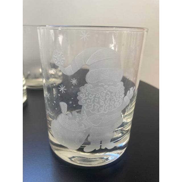 A set of 5 heavy clear glass cocktail glasses with a white etched Santa in pristine condition circa 1970’s from the...