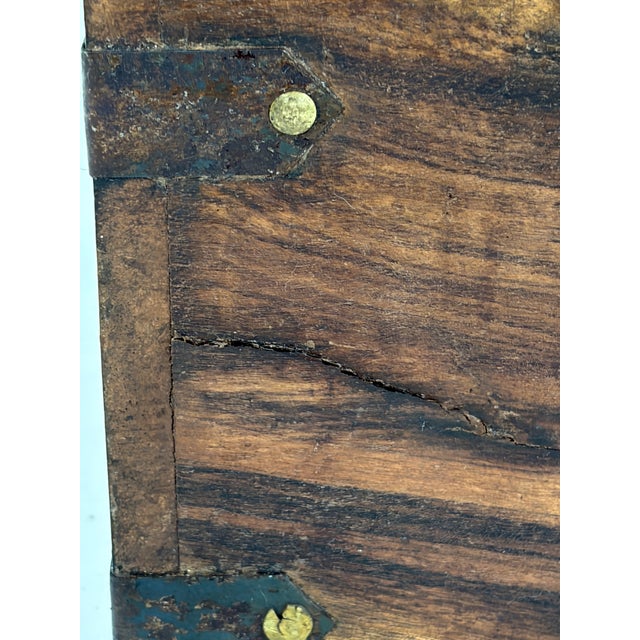Handcrafted wood storage box made in India with dark iron strap hardware, brass-tone rivets, and front latch closure....
