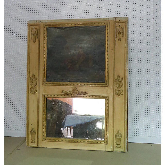 This Antique 18th Century French Louis XVI Style Trumeau Mirror, circa 1790, beautifully merges fine art and functional...