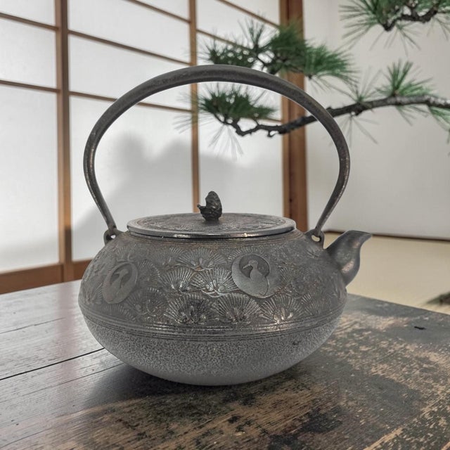 A twentieth-century Japanese Nambu cast-iron tetsubin manufactured by Oigen Chuzo Co., Ltd. of Iwate Prefecture and...