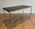 This very sleek and elegant neoclassical style coffee table is made of brass with a black leather top. It is a French work...
