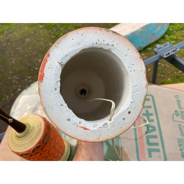This vintage pair of MCM ceramic pottery orange lamps with a brutalist design is a unique addition to any space. The large...