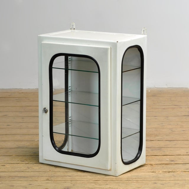 Medicine cabinet (wall unit) from a hospital. Made of iron and glass that is clamped into the steel by a rubber strip....
