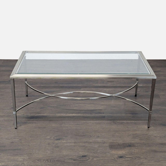 Bronze and gunmetal frame, beveled glass inset top, and decorative curved stretcher base. Brand: Ethan Allen . No makers...