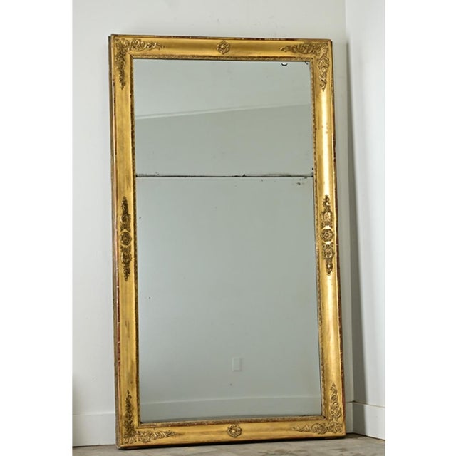Dimension: 71.25"H x 40.25"W x 3.33"D This French Empire mantel mirror (c. 1800) exhibits calculated restraint in the...