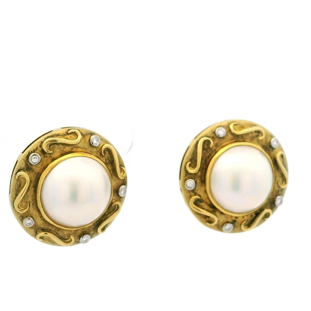 A beautiful pair of Italian 18K yellow gold earrings dating to circa 1980, showcasing luminous natural mabe pearls...
