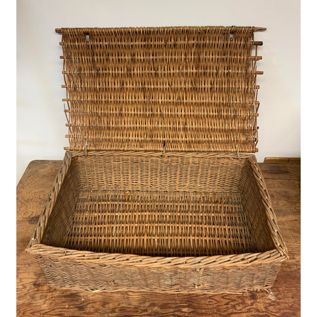 An older vintage to antique handmade woven wicker willow branch basket with hinged hamper style lid. Great box form for...