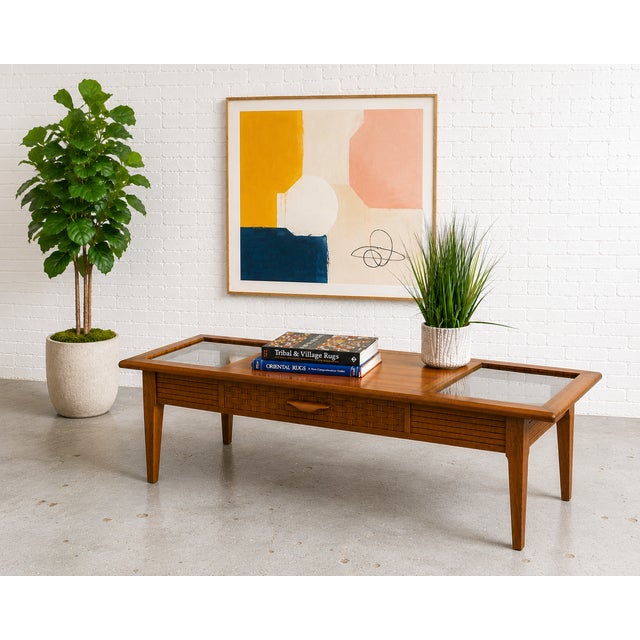 Mid Century Modern Walnut and Smoked Glass Coffee Table by Lane Furniture Co. The table features two smoked glass inserts...