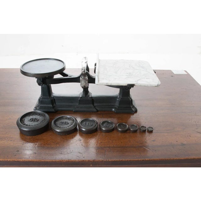 English cast iron scale with a white marble weighing platform. This scale has eight original weights: 4lb, 2lb, 1lb, 8oz,...