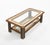 Midcentury amazing rectangular coffee table in wood, leather, glass, brass and mirror. The structure is made of wood with...