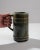 Indulge in the vintage charm of this 1920s European Ceramic Tankard. Crafted in a mesmerizing blue-green ceramic, it...
