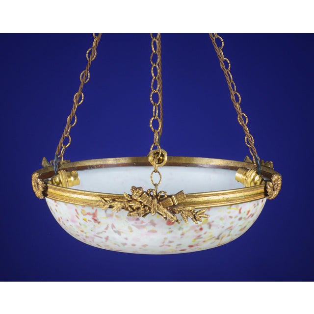 An attractive plafonnier bowl pendant lamp of gilt bronze with floral and torch decoration and an opaline glass shade with...