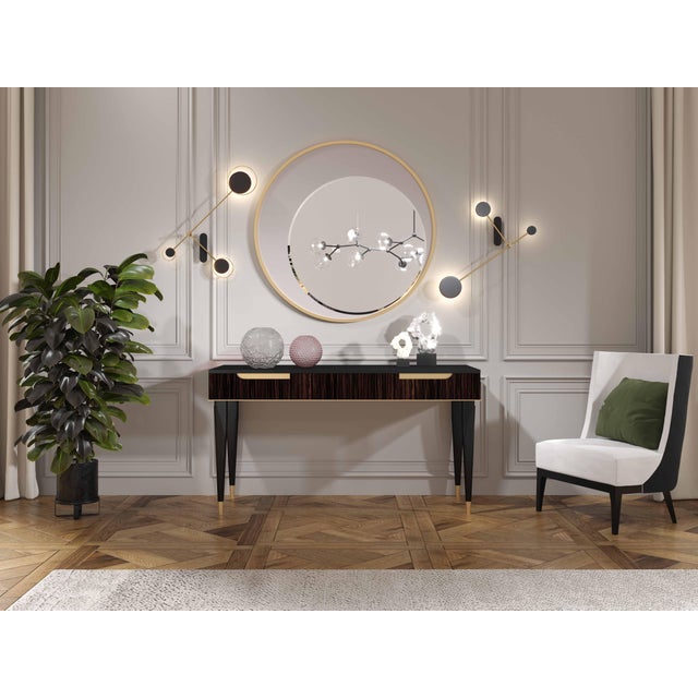 Handcrafted in Italy, this console table features a black-brown lacquer finish with Makassar ebony veneer drawer fronts...