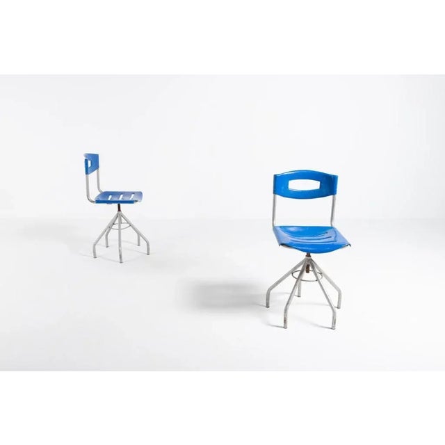Height adjustable chairs/stools with a tubular steel frame and blue plastic seat/backrest, produced in Italy. 8 pieces...