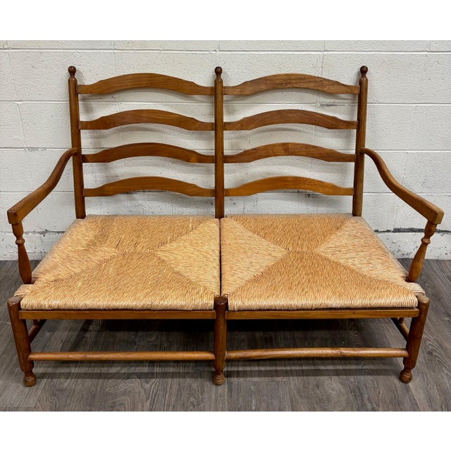 This is a charming vintage Country French double-seat bench, loveseat, or settee featuring classic ladder-back styling,...