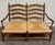 This is a charming vintage Country French double-seat bench, loveseat, or settee featuring classic ladder-back styling,...