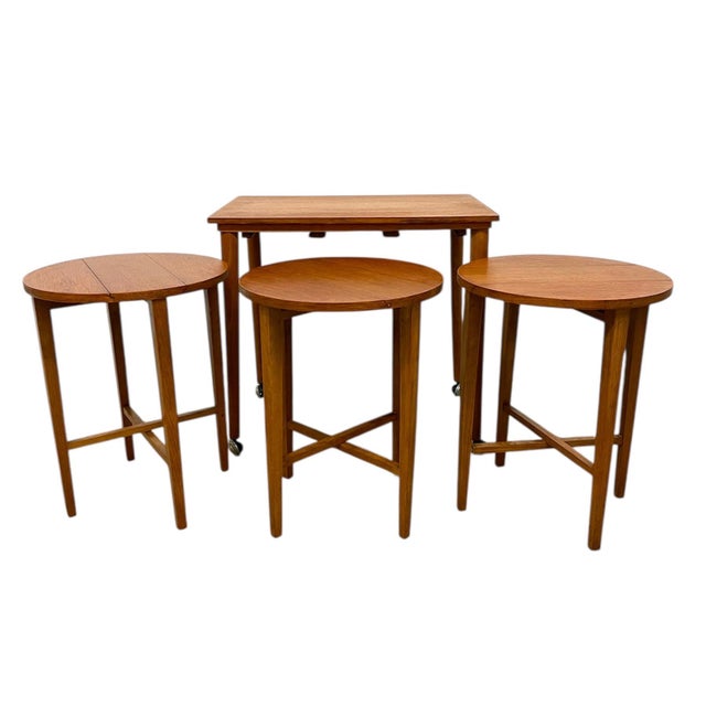This vintage Mid-Century Modern nesting table set-imported from the UK-features a rectangular top table paired with three...
