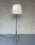 An elegant pair of French floor lamps from the mid-20th century, beautifully crafted in brass and recently finished in...