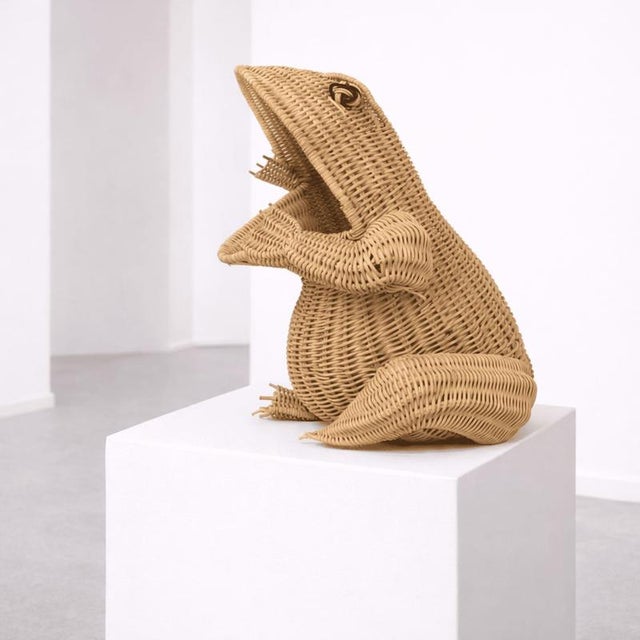 An original frog-shaped woven rattan magazine rack, attributed to Mario Lopez Torres and made in Italy, featuring a strong...
