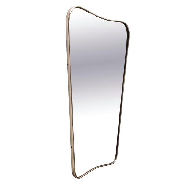 Gorgeous wall or console mirror attributed to Gio Ponti. Its elongated, organic shape is beautifully complemented by a...