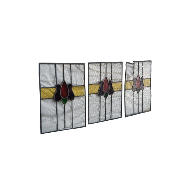 Set of three leaded stained glass window panels. Features pebbled glass in yellow with colorful floral stained glass...