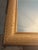 Elegant rectangular wooden wall mirror featuring an antiqued gold frame with an allover fish scale texture pattern. The...