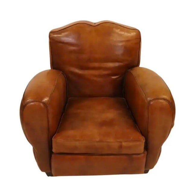 Large pair of mid 20th Century French Art Deco Leather Club Chairs. These chairs date to the mid century and exemplify the...