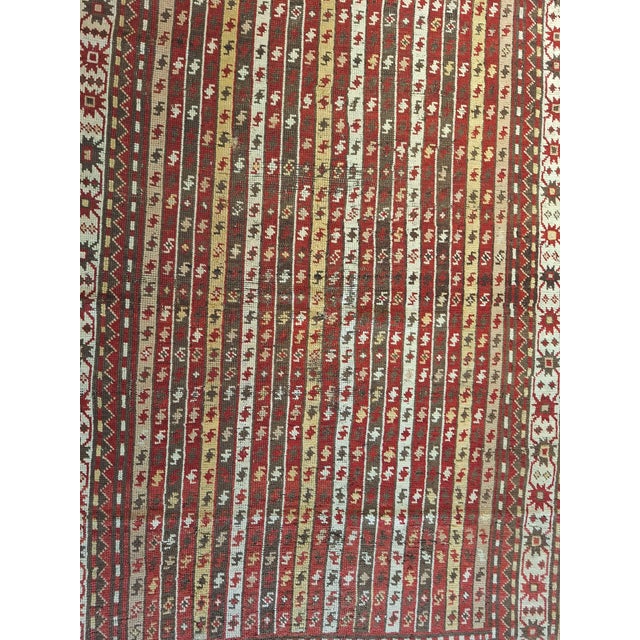 Circa 1900 Russian Caucasian tribal rug featuring a striking vertical stripe field with repeating geometric motifs in deep...