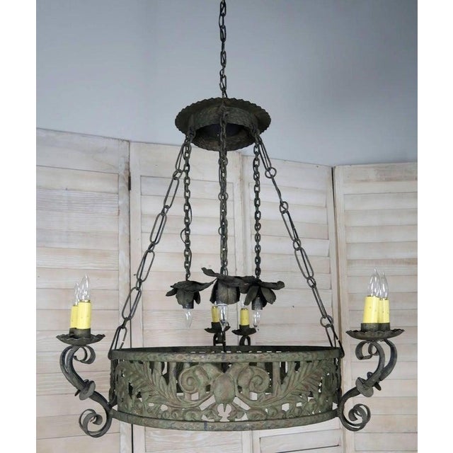 19th century Spanish wrought iron circular chandelier. Six lights in three pairs of two with drip wax candle covers held...