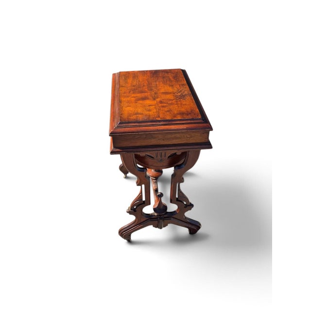 This 19th century American Victorian walnut sewing table has been refurbished with an antique brass handle finish, adding...