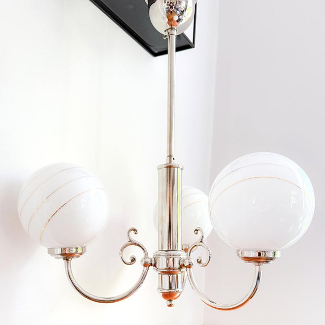 This lovely pendant lamp with 3 opaline glass spheres is truly a feast for the eyes! the elegantly designed chandelier...