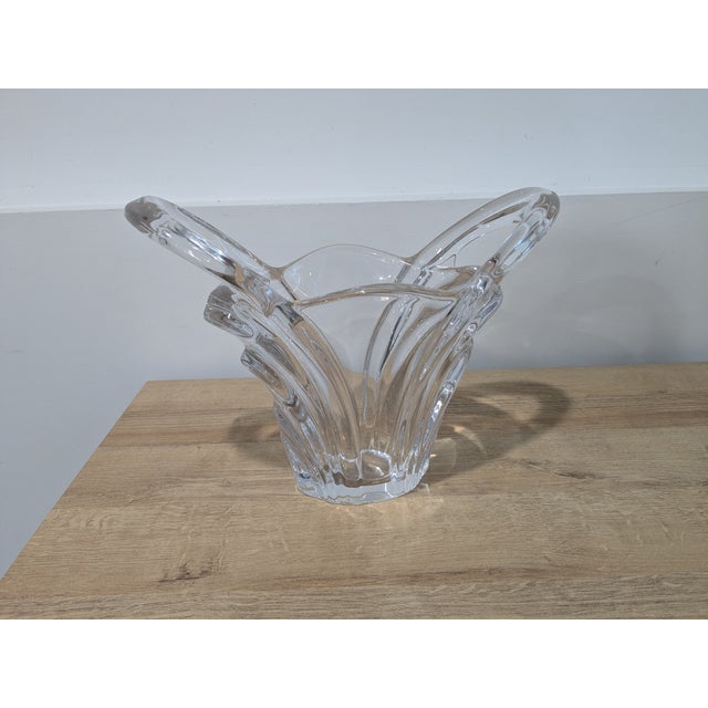 Art Vannes hand blown, handled clear glass vase measuring 12 inches wide by 10 inches tall. The vase was likely produced...