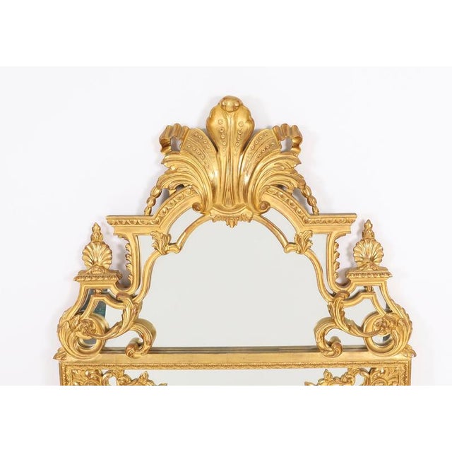 A finely carved antique Louis XVI revival giltwood overmantel mirror, circa 1920 in date. This stunning rectangular mirror...