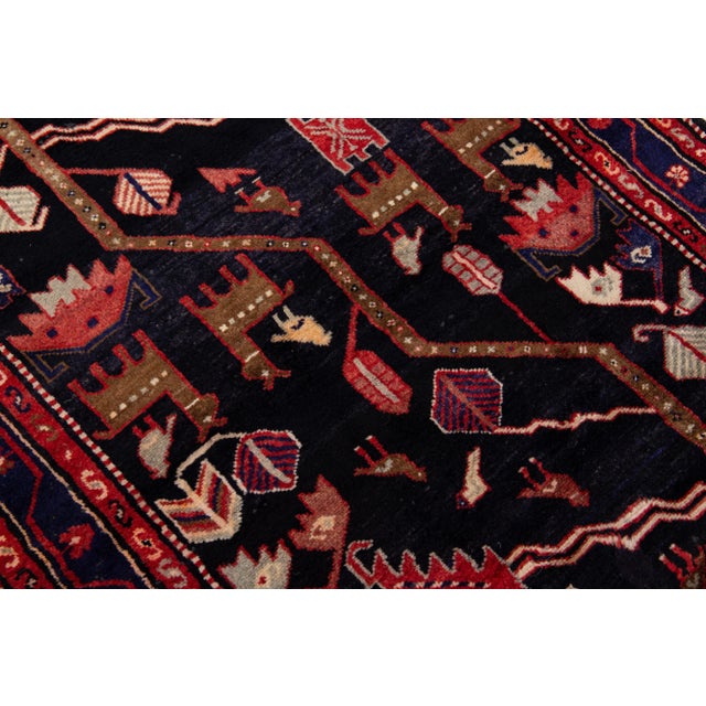 Beautiful vintage Persian Malayer hand-knotted wool rug with a navy blue field. This piece has multicolor accents in an...