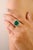This luxurious cocktail ring showcases a captivating 6.43-carat natural emerald centerpiece, measuring approximately 10x10...