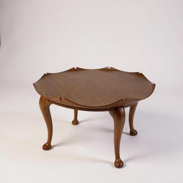 This teak coffee table from the early 1950s features a unique lotus leaf scalloped tabletop that brings mid century charm...