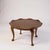 This teak coffee table from the early 1950s features a unique lotus leaf scalloped tabletop that brings mid century charm...