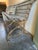 This vintage French-style garden bench features cast iron legs designed to resemble natural tree branches or snakes,...