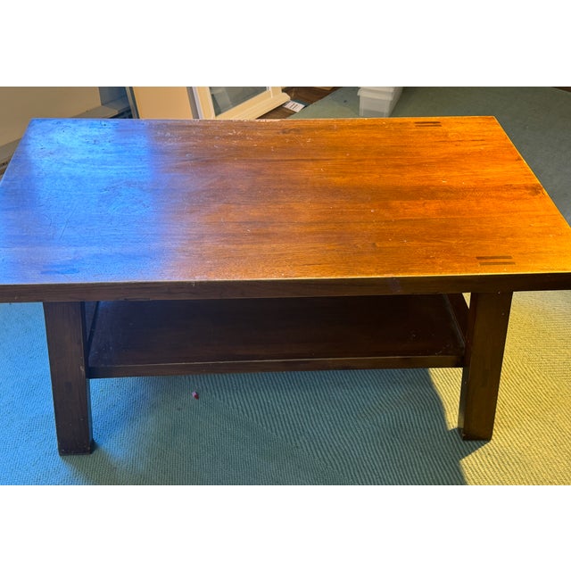 Beautiful wood table with a shelf underneath. It's made from solid wood. It can use a bit of refurbishing as there are...