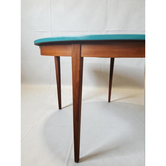 A 1960s table with a top painted with a professional, stain- and scratch-resistant teal satin PU lacquer. The veneer on...