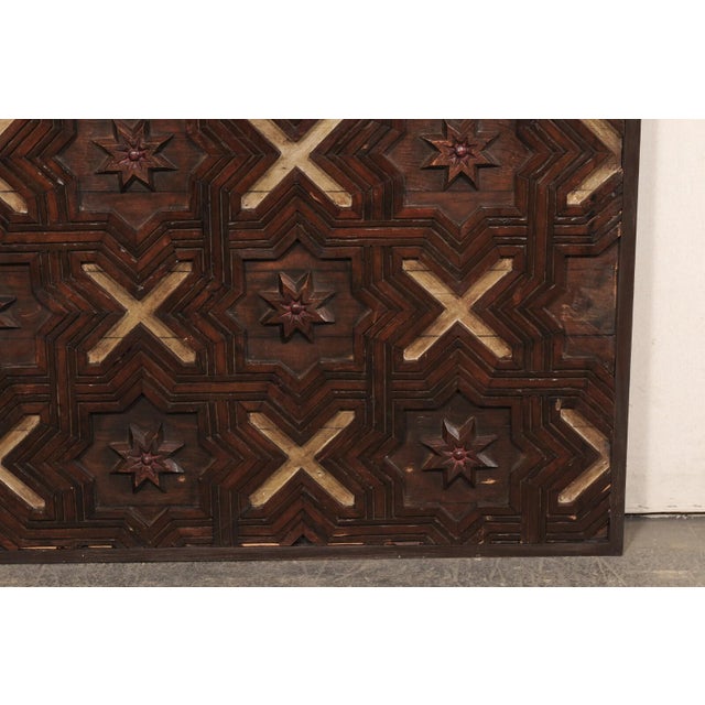 A decoratively paneled Spanish wood wall panel with Moorish influences from the 18th Century. This antique wall decoration...